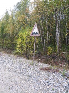 Old road-side sign on wooden stick